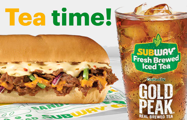 A footlong sandwich on Subway branded paper and a glass of Gold Peak fresh brewed iced tea.